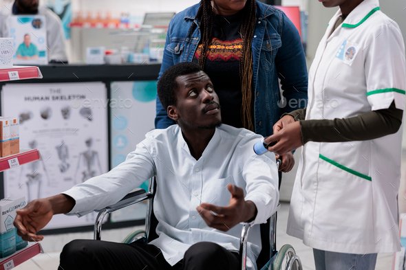 Pharmacy consultant explaining man with disability medications instruction